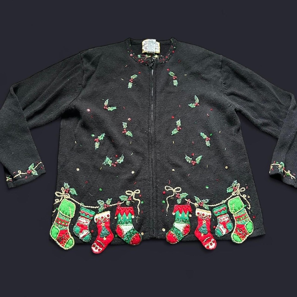 Black Christmas sweater with green and red embroidery, featuring stockings bows